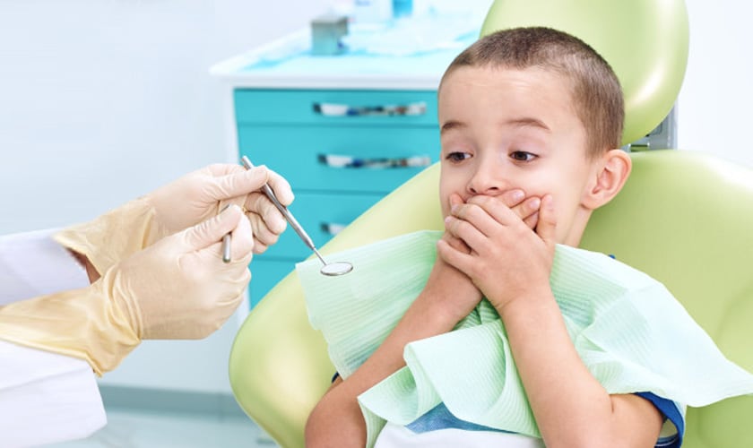 scared child in a dental chair